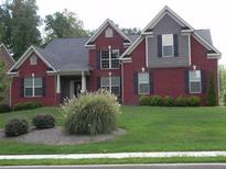 Charming brick two-story home with a well-manicured front yard and classic architectural details at 141 Windward Hills, Mcdonough, GA 30253