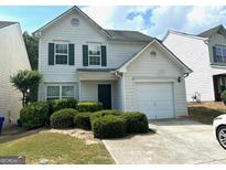 Traditional two-story home with a one-car garage and well-maintained landscaping at 9515 Lakeview Rd, Union City, GA 30291