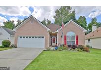 Charming brick home with a well-manicured lawn and vibrant flowerbeds enhancing curb appeal at 170 Habersham Dr, Fayetteville, GA 30214