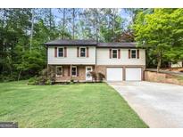 Charming two-story home featuring a well-manicured lawn and attached two-car garage at 2687 Fairfield Sw Dr, Marietta, GA 30064