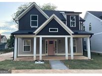 Charming new two-story home featuring a welcoming front porch and a pink front door at 3189 Jackson, Hapeville, GA 30354