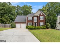 Charming brick front home with a two-car garage, lush lawn and beautiful landscaping at 5409 Trumpet Vine Se Trl, Mableton, GA 30126