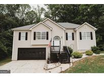 Charming two-story home featuring a well-maintained front yard and a welcoming entrance with an American flag at 228 Hunt Club Cir, Temple, GA 30179