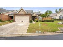 Charming brick home with well-manicured lawn and attached two-car garage in a quiet neighborhood at 3206 Abbott Dr # 12, Powder Springs, GA 30127
