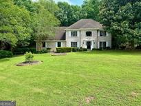 Charming two-story brick home with landscaped front yard and lush green lawn at 4786 Carlene Sw Way # Iv, Lilburn, GA 30047
