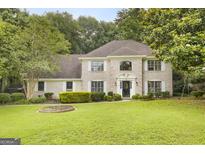 Charming two-story brick home with a well-manicured lawn and beautiful landscaping at 4786 Carlene Sw Way # Iv, Lilburn, GA 30047