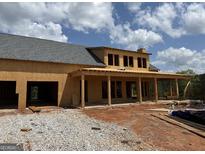 New construction showing covered porch and garage, framed with wood and featuring a gray shingled roof on a sunny day at 51 Alatus Rd, Hogansville, GA 30230