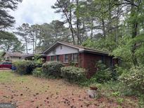Charming brick home with mature trees and landscaping, offering a serene and private setting at 4720 Ben Hill Rd, South Fulton, GA 30349