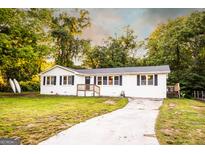Charming home with a well-maintained yard, crisp white exterior, and inviting front porch entrance at 361 N Dogwood Ave, Social Circle, GA 30025
