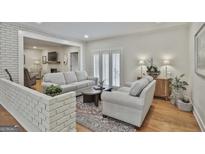 Comfortable living room with hardwood floors, neutral furniture, and ample natural light at 502 Pine Cir, Peachtree City, GA 30269
