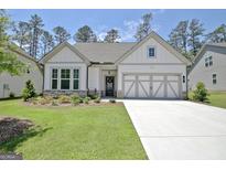 Charming single-Gathering home featuring manicured lawn, stone accents, and neutral color palette at 82 Airmont Dr, Sharpsburg, GA 30277