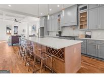 Modern kitchen island with a white countertop, wine rack, and seating for a perfect gathering space at 2018 Presley, Atlanta, GA 30317