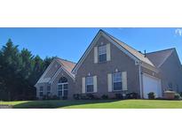 Charming brick home featuring well-maintained landscaping and a manicured lawn at 3008 Brighton Ct, Conyers, GA 30094