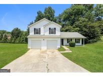 Charming two-story home with a two-car garage and well-maintained front yard, perfect for suburban living at 3587 Oakvale Ave, Decatur, GA 30034