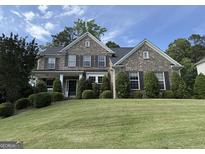Beautiful brick home with manicured front lawn and symmetrical landscaping in a lovely neighborhood at 2750 Brentwood Estates Ct, Cumming, GA 30041