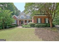 Charming two-story brick home with a manicured lawn and a welcoming front porch at 102 Passage Point, Peachtree City, GA 30269