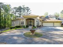 Stunning home featuring a circular driveway, fountain, and well-manicured landscaping at 1010 Forest Overlook Sw Dr, Atlanta, GA 30331