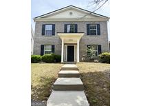 Charming two-story brick home featuring a welcoming entrance and well-maintained landscaping at 2517 Walter Way, Stockbridge, GA 30281