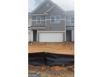 Charming new construction townhome with a clean white garage door and gray exterior at 1017 Merritt Dr Edinberg Dr # 103, Villa Rica, GA 30180