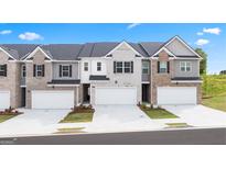Charming townhomes showcasing unique exteriors, two-car garages, and well-maintained landscaping at 325 Silver Moon Dr, Loganville, GA 30052