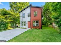 Charming two-story home features a modern design with a well-manicured lawn and a concrete driveway at 1835 Taylor Ave, East Point, GA 30344