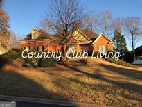 Charming brick home featuring a landscaped yard and classic architectural details at 116 Royal Burgess Way, Mcdonough, GA 30253