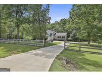 Charming two-story home with a quaint front porch and fenced yard at 109 Cannon Road, Sharpsburg, GA 30277