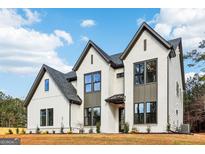 Stunning two-story home with white brick, dark trim, and modern farmhouse details at 3735 Tamiami Trl, Cumming, GA 30041