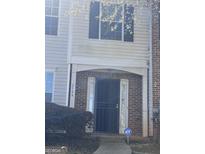 Charming townhome entrance featuring a secure black metal door and classic brick accents at 2754 Vining Ridge Terrace, Decatur, GA 30034