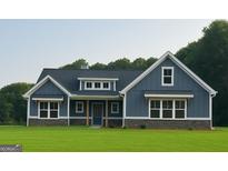 Charming blue home featuring stone accents, a covered porch, and large windows showcasing curb appeal at 1273 Jersey Social Circle Rd, Covington, GA 30014
