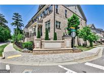 Attractive brick townhome featuring professionally landscaped grounds and manicured shrubbery at 2282 Mclean Chase Se, Smyrna, GA 30080