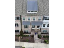 Charming brick townhome featuring a landscaped front yard and covered entryway at 2282 Mclean Chase Se, Smyrna, GA 30080
