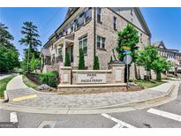 Brick townhomes at Park at Paces Ferry with lush landscaping on a tree-lined street at 2282 Mclean Chase Se, Smyrna, GA 30080