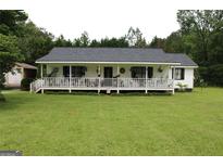 Charming single-Gathering home with a covered front porch, set on a lush green lawn at 124 Wynn Rd, Mcdonough, GA 30252