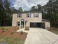 Inviting two-story home featuring a spacious driveway and a convenient two-car garage at 20 Emerald Ln # 1, Covington, GA 30014