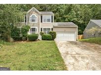Charming two-story home with stone accents and a two-car garage nestled amongst mature trees at 1960 Morning Nw Walk, Acworth, GA 30102