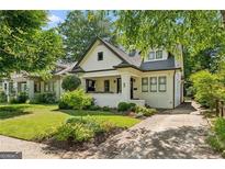 Charming craftsman home featuring a manicured lawn and inviting brick-lined driveway, perfect for suburban living at 622 Seminole Ne Ave, Atlanta, GA 30307