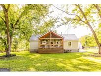 Charming home with a metal roof, inviting front porch, and a lush green lawn at 316 Gaithers Rd, Mansfield, GA 30055