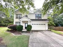 Charming two-story home featuring a well-manicured lawn, a two-car garage and welcoming front porch at 3814 Clear Lake Nw Way, Acworth, GA 30101