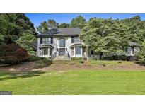 Charming two-story home with a well-manicured lawn, brick exterior, and lots of curb appeal at 209 Smokerise Trce, Peachtree City, GA 30269