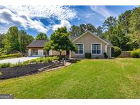Charming one-story home with a beautifully landscaped front yard and inviting curb appeal at 255 Mcintosh Estates Dr, Sharpsburg, GA 30277