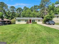 Charming one-story home with a well-manicured lawn and a classic brick exterior, perfect for suburban living at 3059 Will Rogers Se Pl, Atlanta, GA 30316
