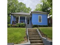 Charming blue home with a welcoming front porch and well-maintained lawn at 1761 Hosea L Williams Dr, Atlanta, GA 30317