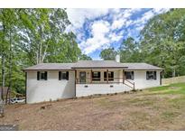 Charming ranch-style home with a welcoming front porch and freshly painted white brick at 126 Country Acres Ct, Mcdonough, GA 30253