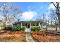Charming home with a welcoming front porch and well-maintained yard at 577 Rivers Rd, Fayetteville, GA 30214