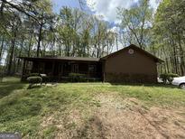 Traditional single-story home with a covered porch and wood and stone exterior at 5350 Hearn, Ellenwood, GA 30294