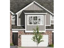 Charming townhome featuring brick accents and a two-car garage, blending modern design with classic materials at 2024 Piccolo Ct # 228, Mcdonough, GA 30252