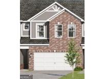 Charming two-story townhome showcasing brick and gray siding, complemented by an attached two-car garage at 2036 Piccolo Ct # 225, Mcdonough, GA 30252