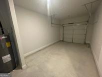 View of an attached garage with cement floor and garage door at 5257 Carrie Dr, Morrow, GA 30260