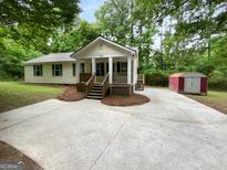 Charming single-Gathering home with a well-maintained lawn and inviting front porch at 355 New Marietta Hwy, Roswell, GA 30075